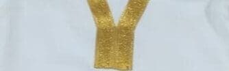 A gold ribbon with the letter y written on it.