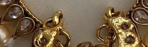 A close up of some gold chains and coins