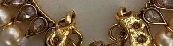 A close up of some gold chains and coins